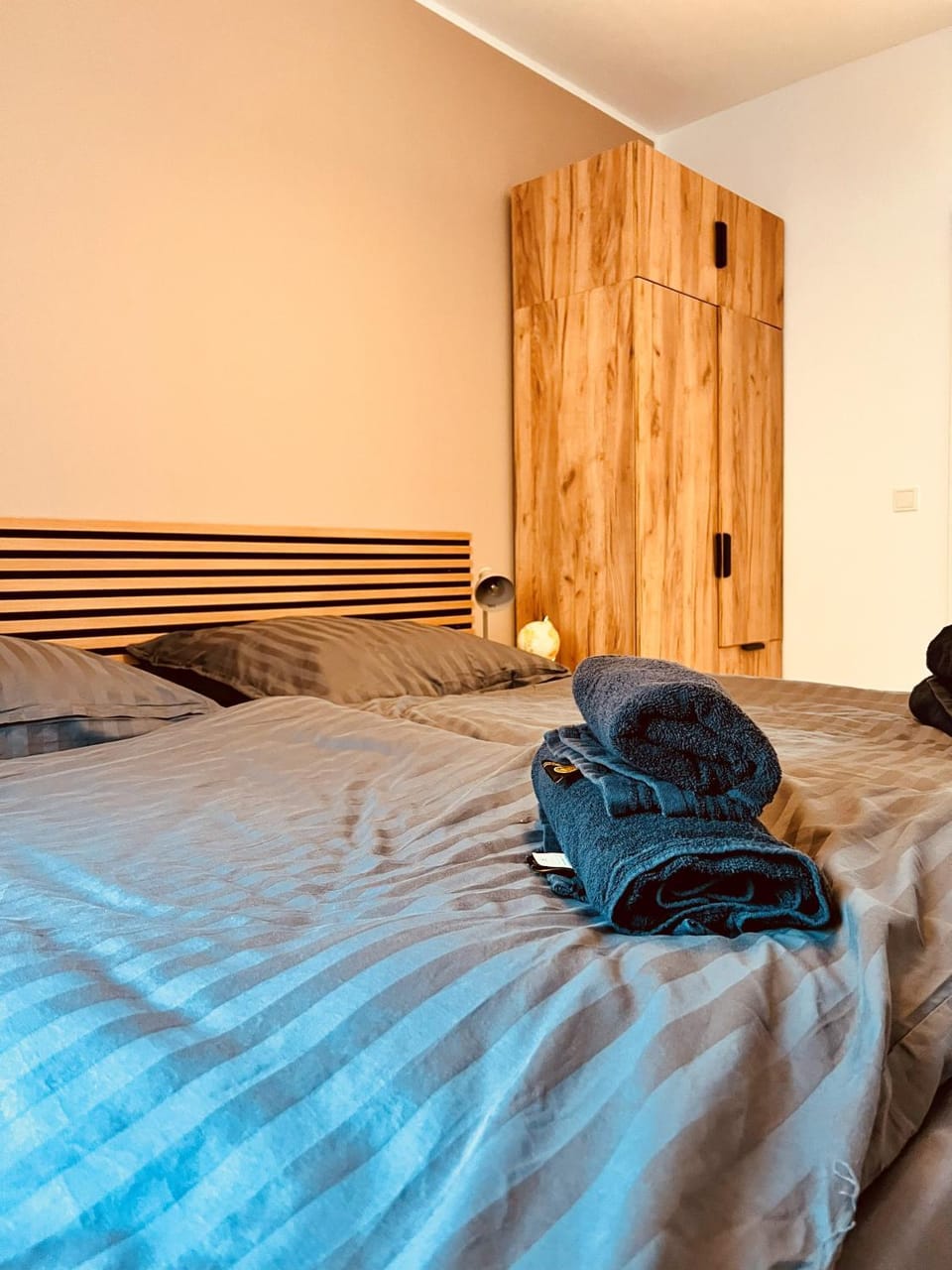 Bed, towels, wardrobe