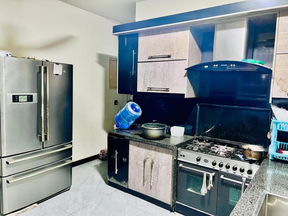 Kitchen or kitchenette, dishwasher, oven, stove
