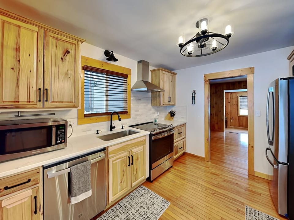 Kitchen or kitchenette, furniture, microwave, stove, washing machine