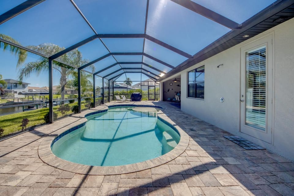 Canalfront Island Escape with Pool, Lanai & Dock - Antigua Villa - Roelens House in Cape Coral
