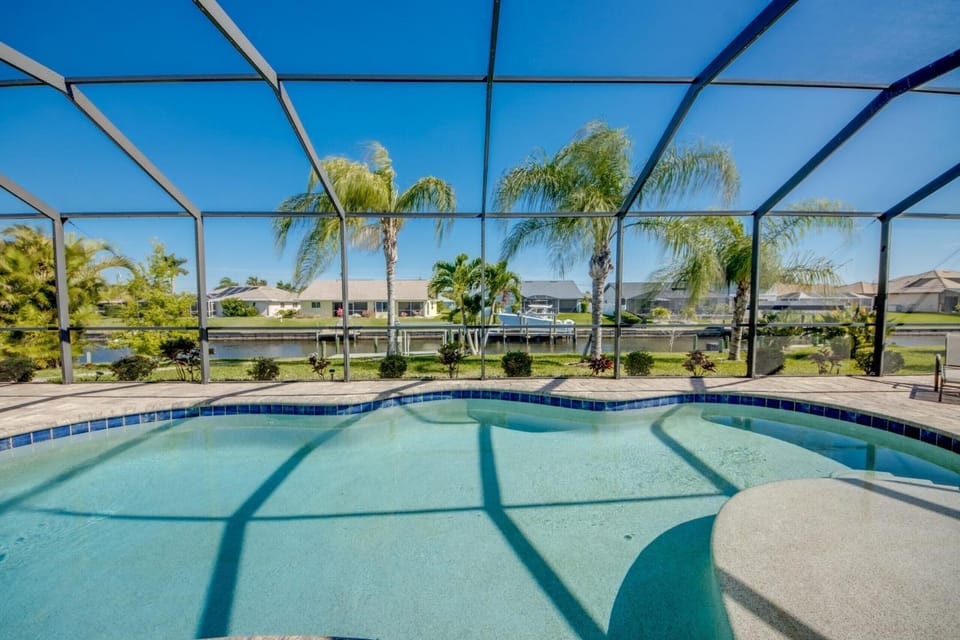 Canalfront Island Escape with Pool, Lanai & Dock - Antigua Villa - Roelens House in Cape Coral