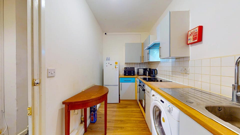 Kitchen or kitchenette, oven, stove, toaster, washing machine
