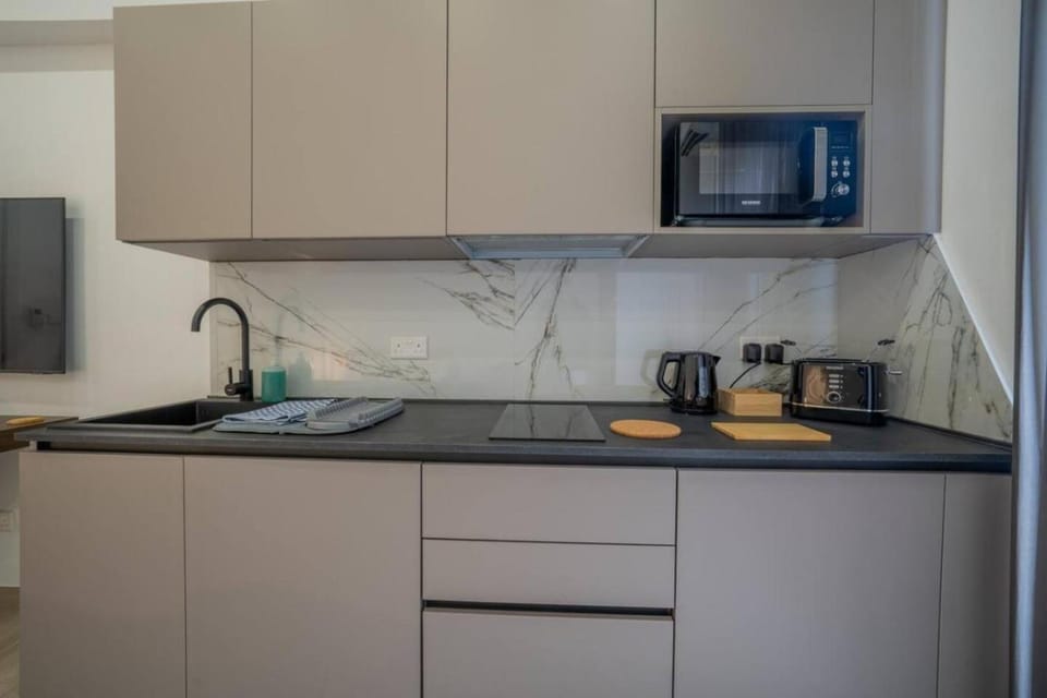 Kitchen or kitchenette, microwave, stove, toaster