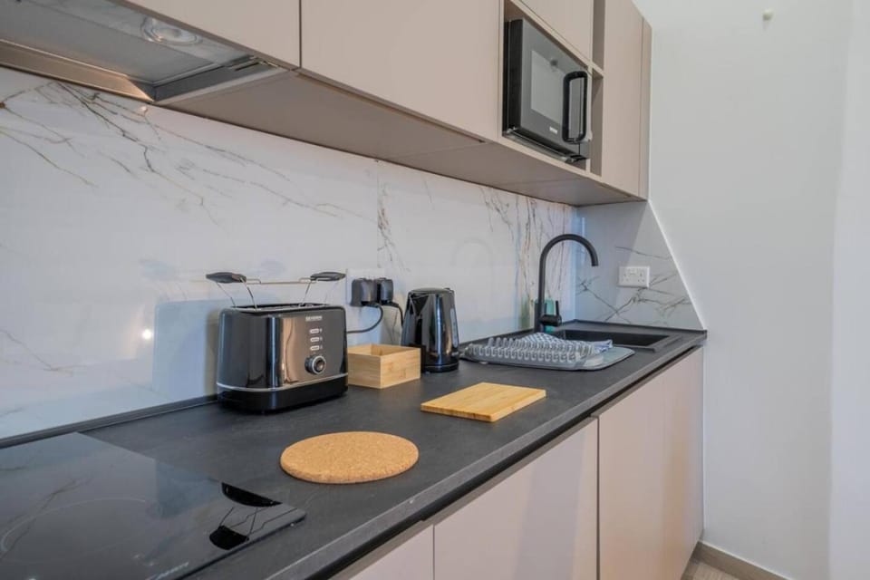 Kitchen or kitchenette, microwave, stove, toaster