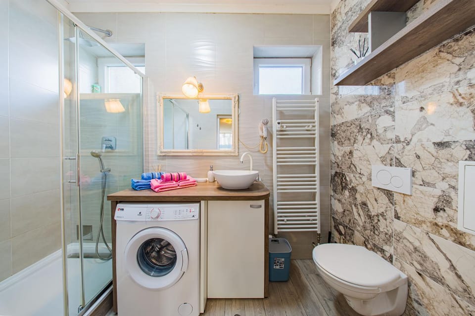 Shower, Toilet, Bathroom, towels, washing machine, dryer
