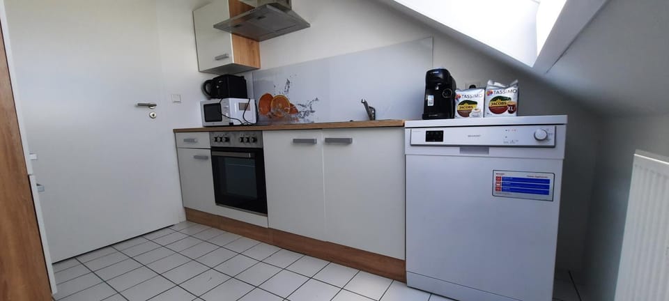 Kitchen or kitchenette, dishwasher, oven, stove