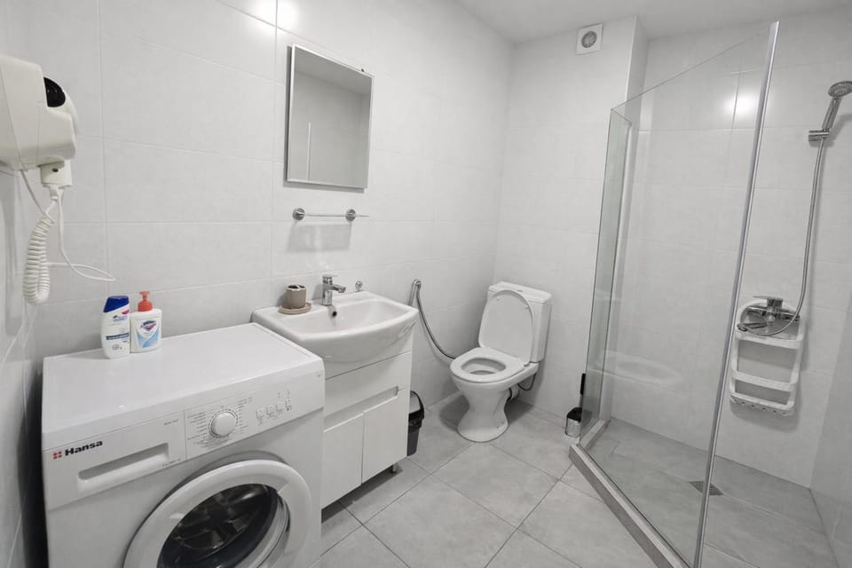 Shower, Toilet, Bathroom, bidet, towels, washing machine, dryer