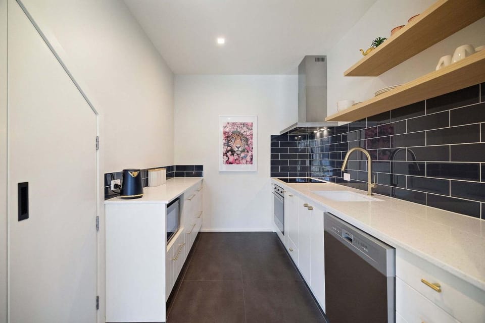 Kitchen or kitchenette, dishwasher, oven, stove