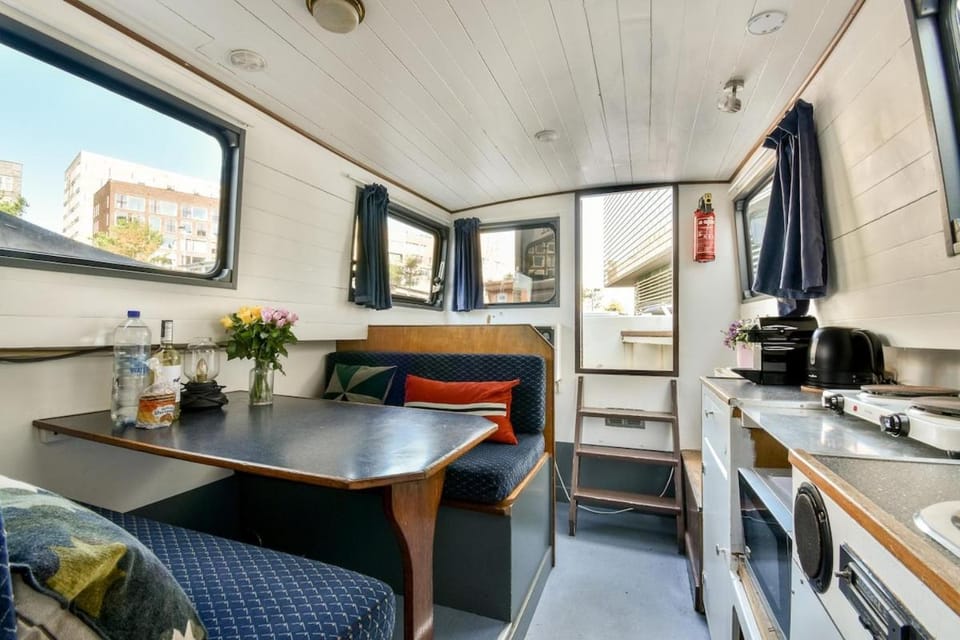Orginal Dutch houseboat city center 'WIEL' Docked boat in Amsterdam
