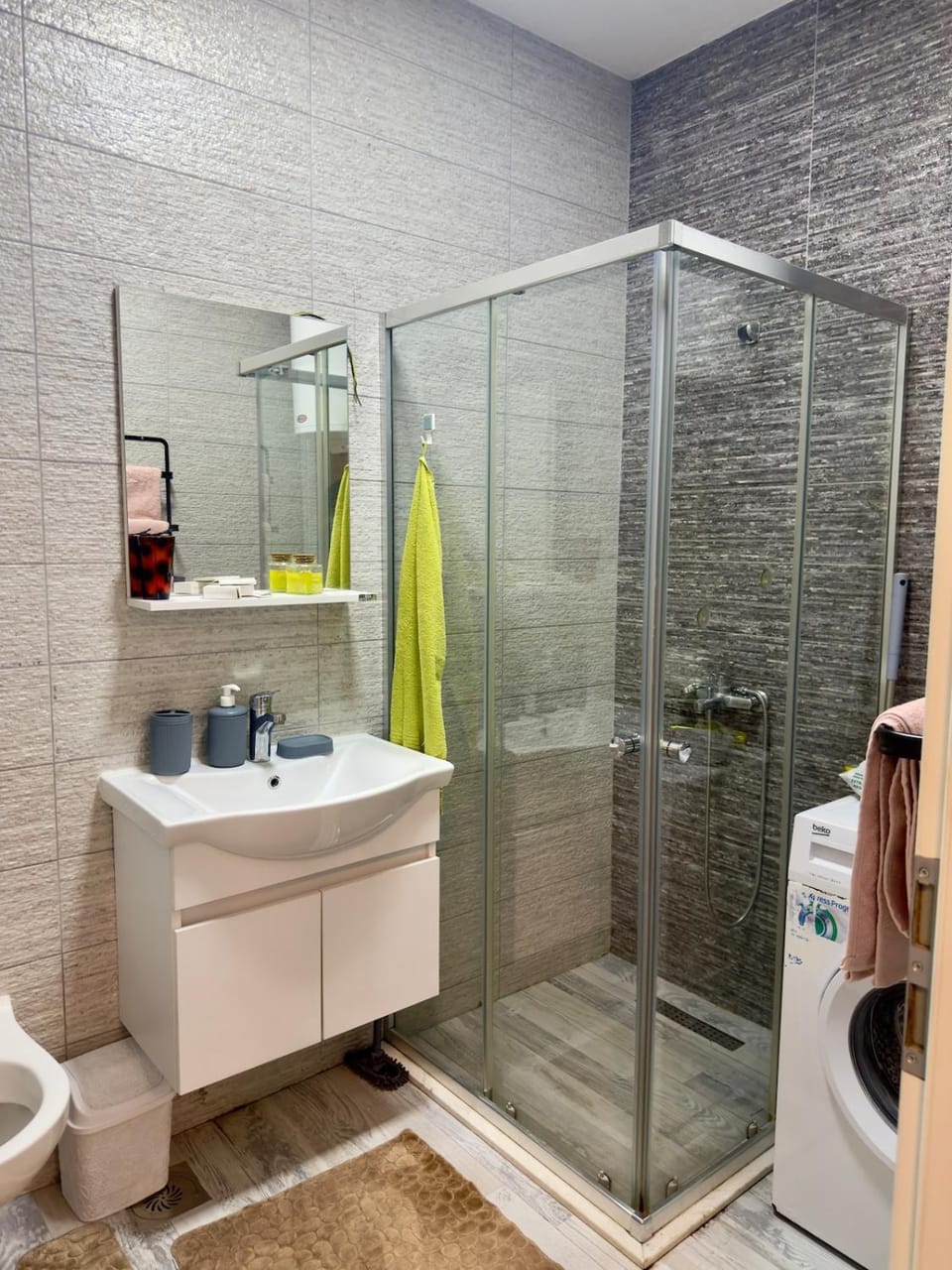 Shower, Toilet, Bathroom, flat iron, hair dryier, towels, washing machine