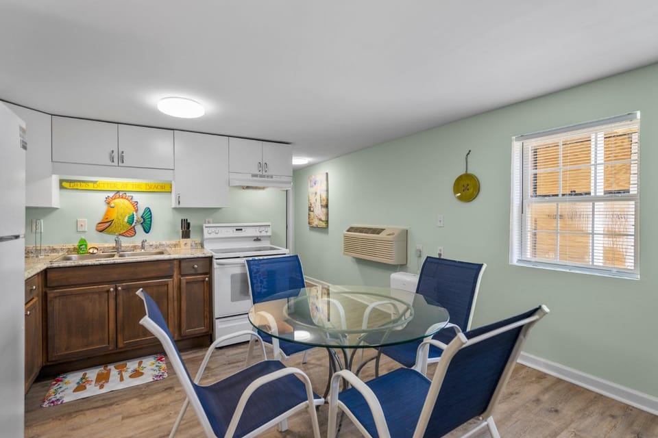Kitchen or kitchenette, Dining area, furniture, microwave, stove, air conditioner