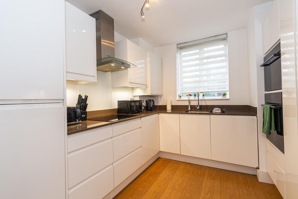 Kitchen or kitchenette, dishwasher, oven, stove