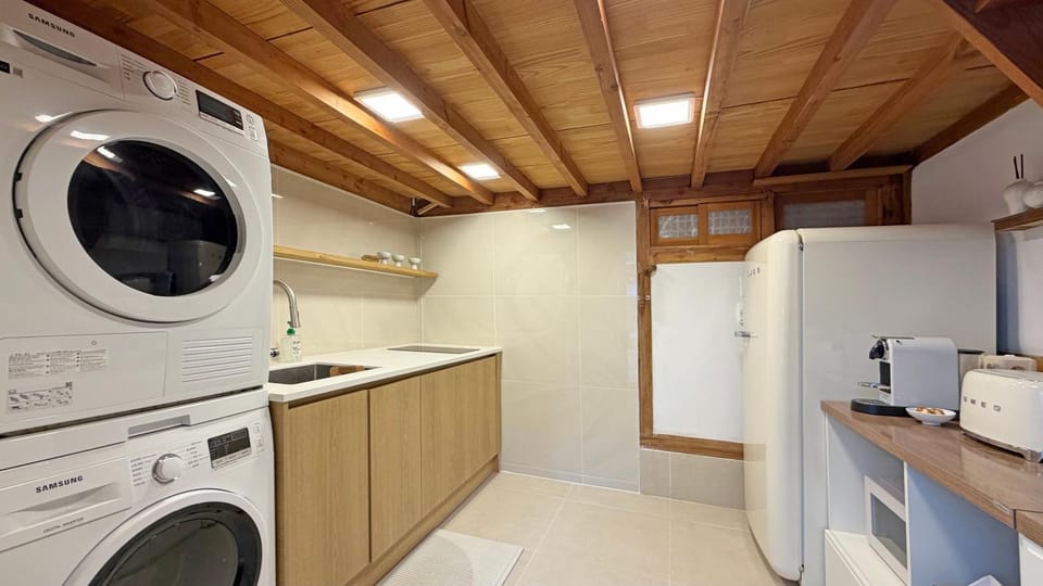 Kitchen or kitchenette, stove, washing machine, dryer