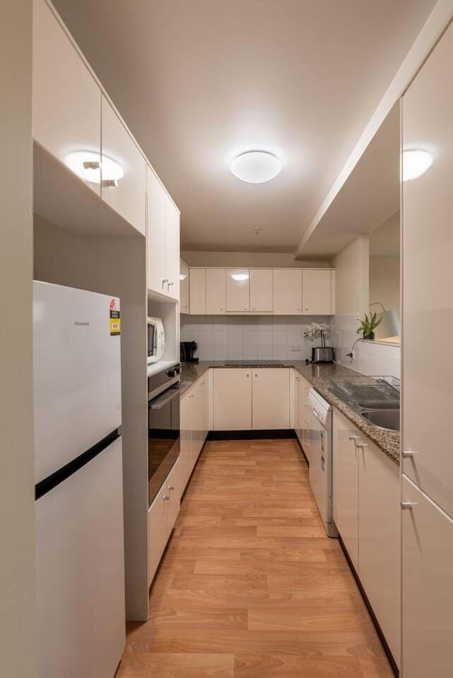 Kitchen or kitchenette, dishwasher, oven, stove