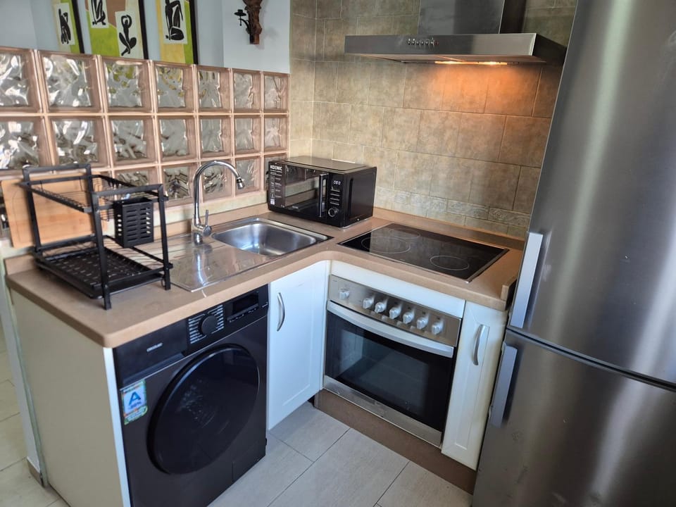 Kitchen or kitchenette, microwave, oven, washing machine