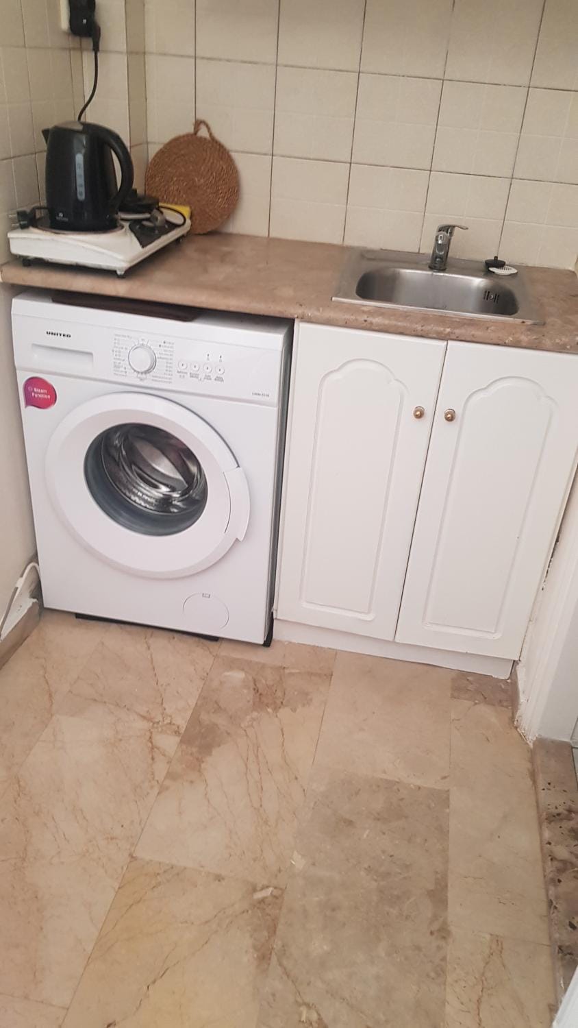 Kitchen or kitchenette, washing machine