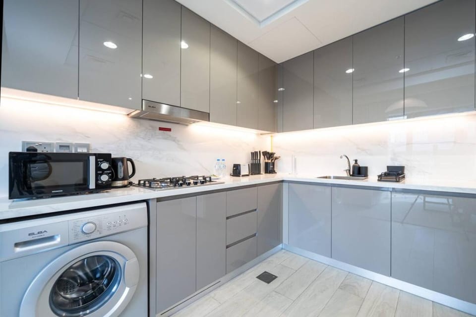Kitchen or kitchenette, microwave, stove, washing machine