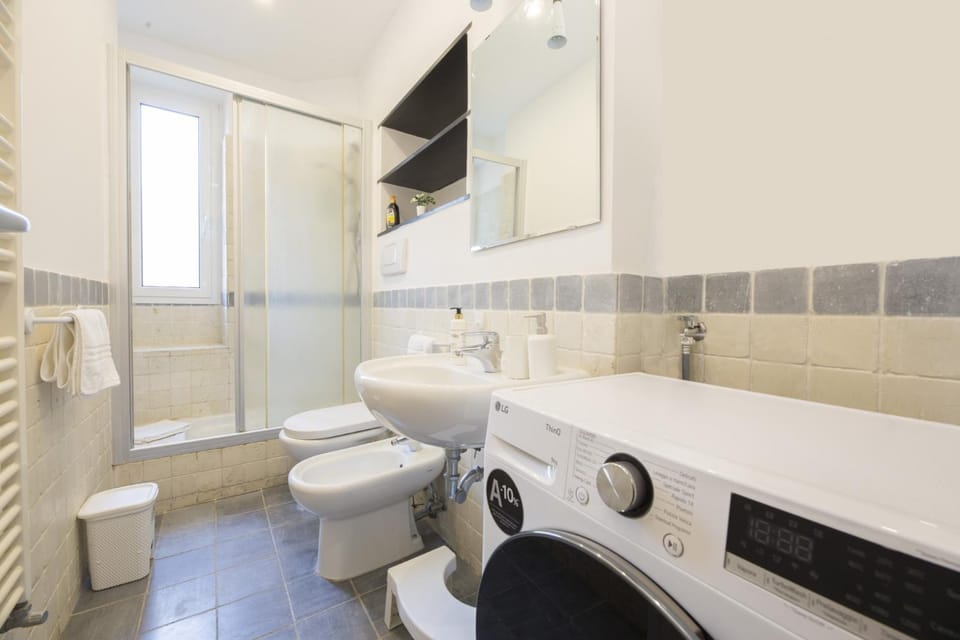 Shower, Toilet, Bathroom, bidet, towels, washing machine, dryer