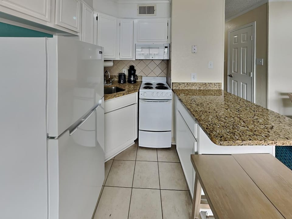 Kitchen or kitchenette, microwave, stove, kitchen, air conditioner