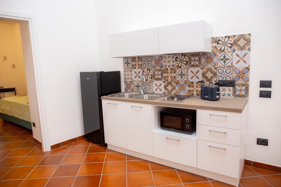 Kitchen or kitchenette, microwave, stove, toaster