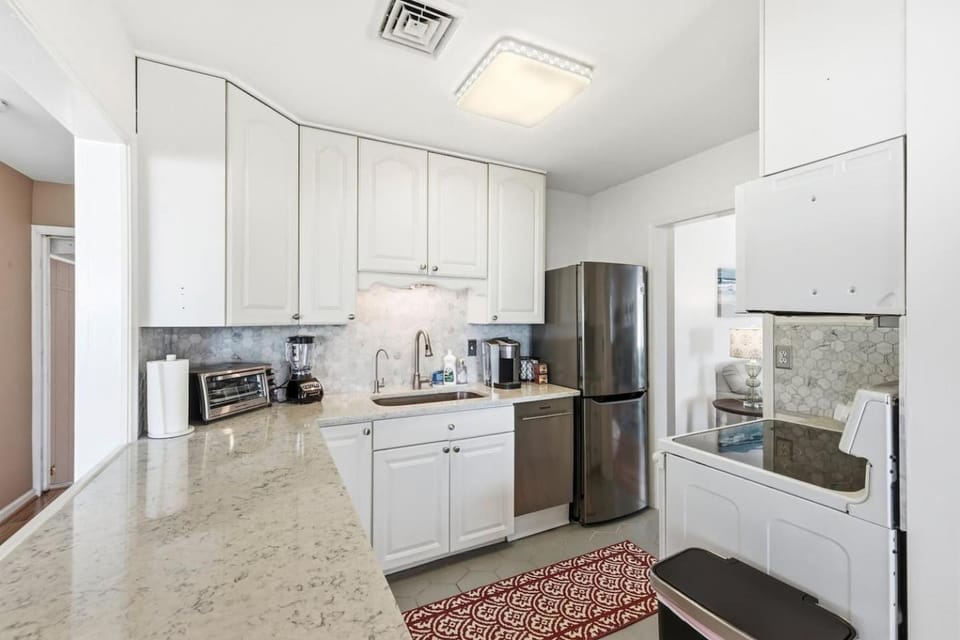 Kitchen or kitchenette, dishwasher, oven, stove