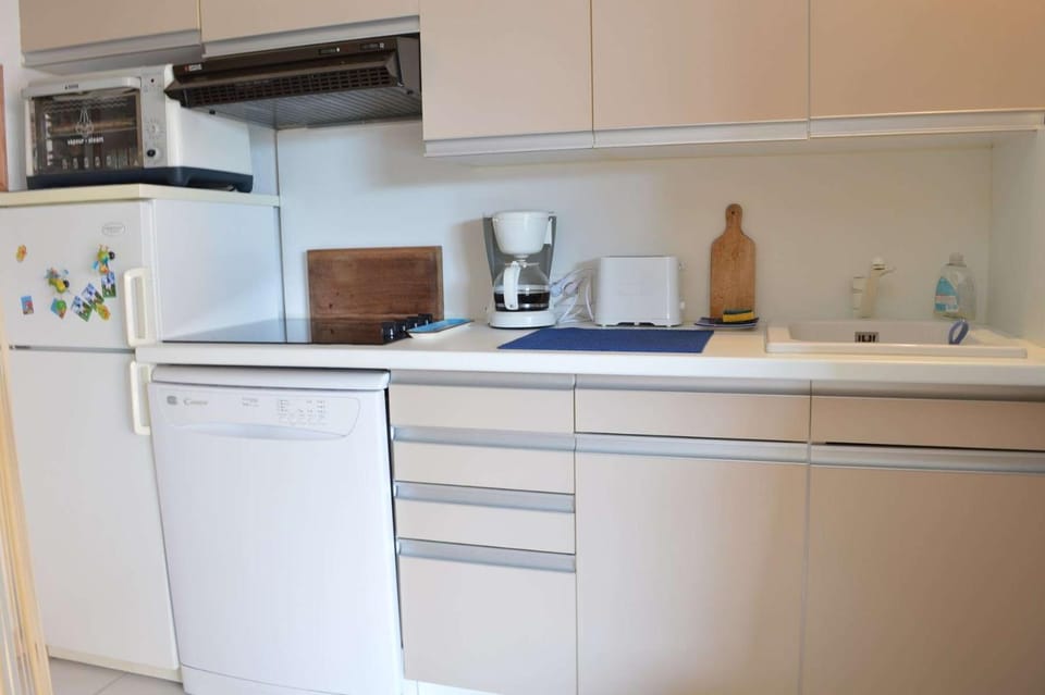 Kitchen or kitchenette, dishwasher, oven, stove