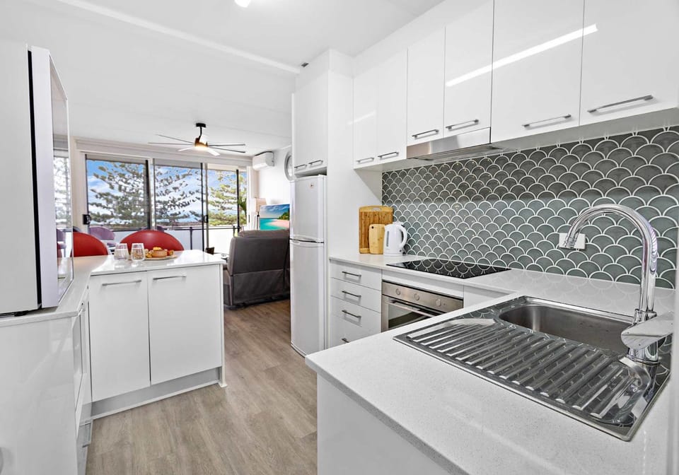 Kitchen or kitchenette, dishwasher, oven, stove