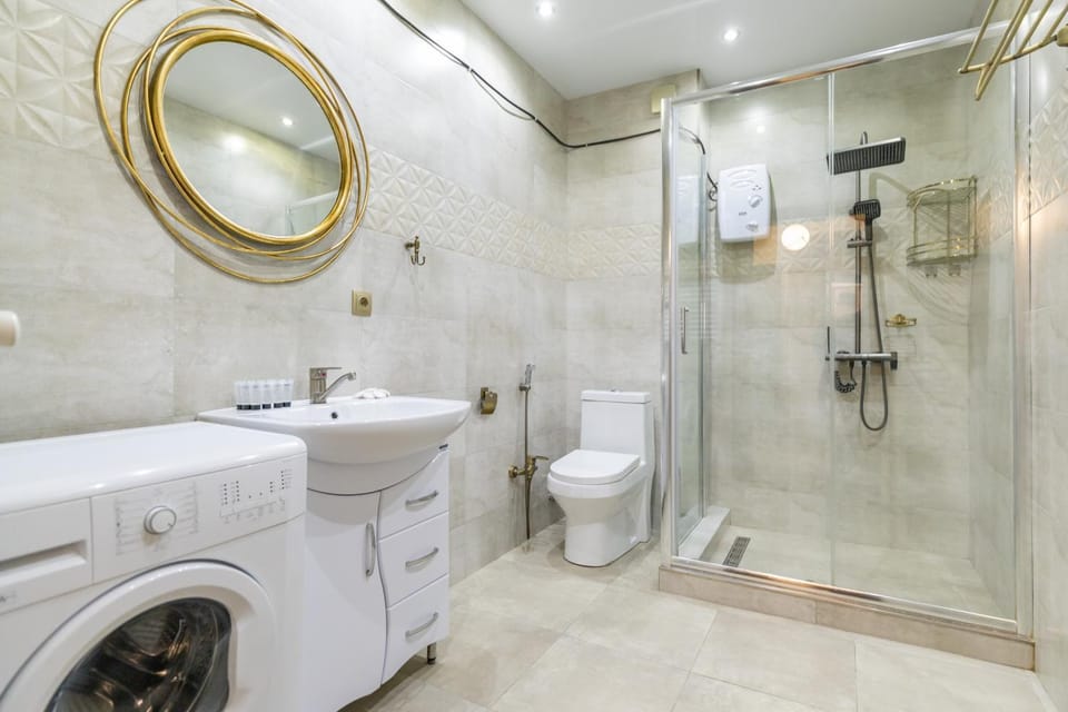 Shower, Toilet, Bathroom, bidet, towels, washing machine, dryer