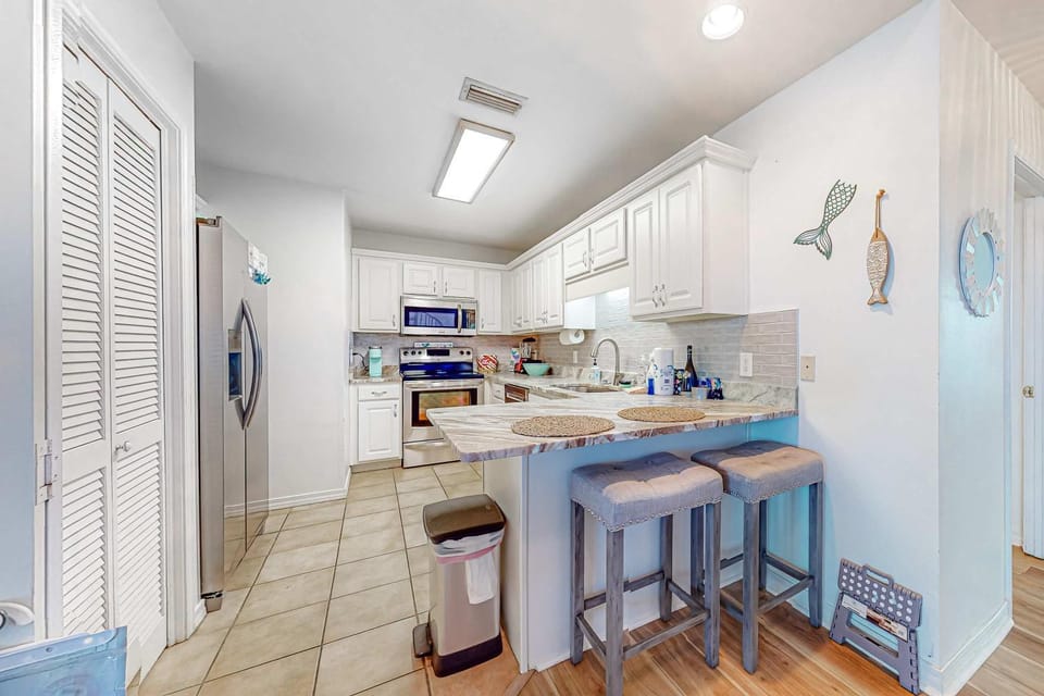 Sunlit two-story condo with pool walk one block to the beach House in West Beach