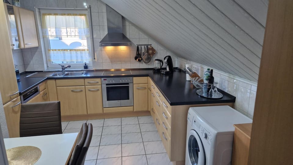 Kitchen or kitchenette, dishwasher, oven, stove, toaster, washing machine