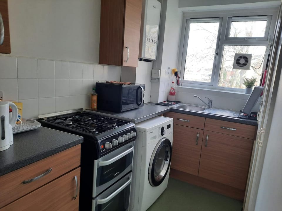 Kitchen or kitchenette, stove, toaster, washing machine, dryer