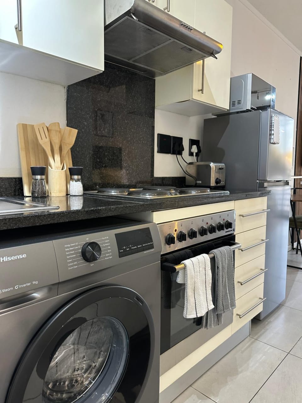Kitchen or kitchenette, oven, stove, toaster, washing machine