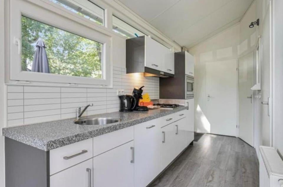 Kitchen or kitchenette, dishwasher, oven, stove