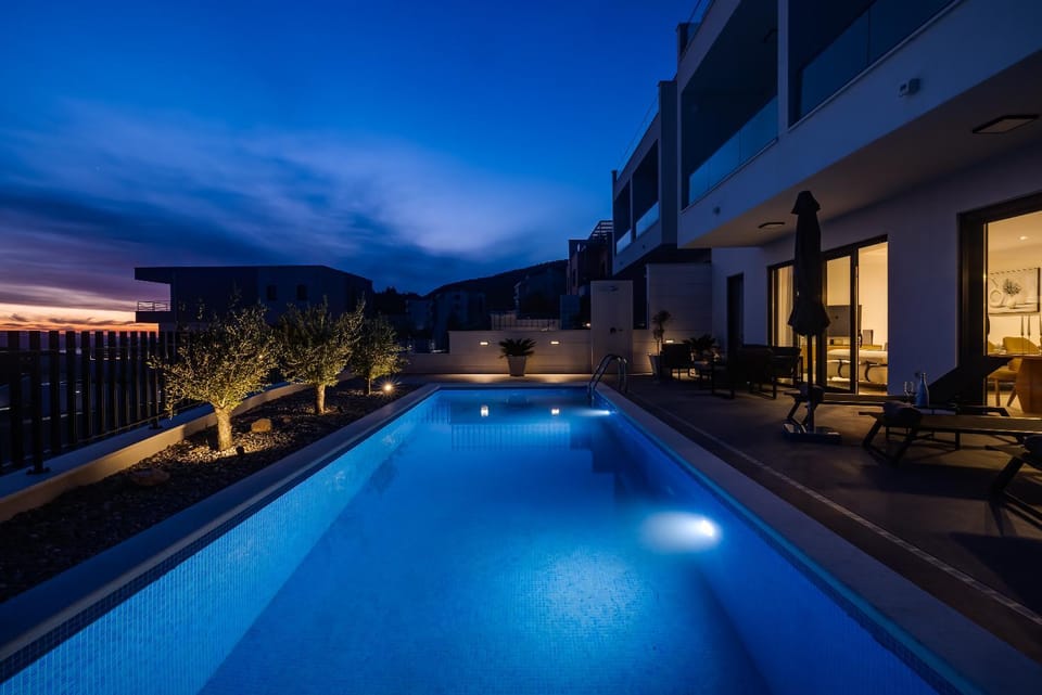 Property building, Patio, Night, Natural landscape, Pool view, Swimming pool, sunbed