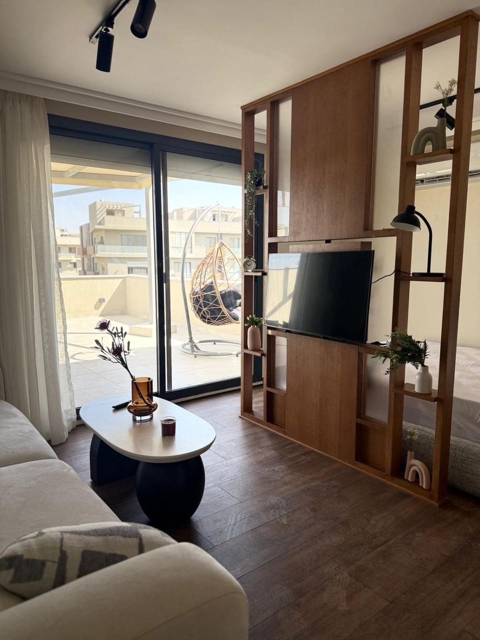 A luxurious bedroom and a cozy living area with a stunning view of the swimming pool Apartment in New Cairo City