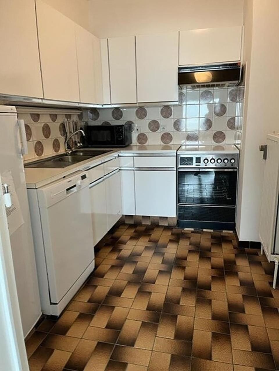 Kitchen or kitchenette, dishwasher, oven, stove