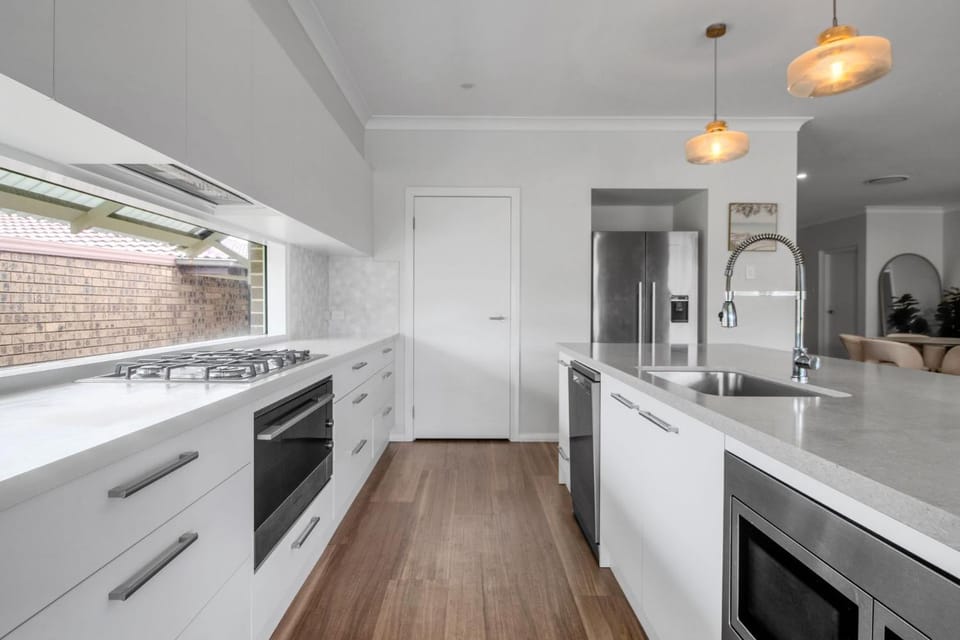 Kitchen or kitchenette, dishwasher, oven, stove