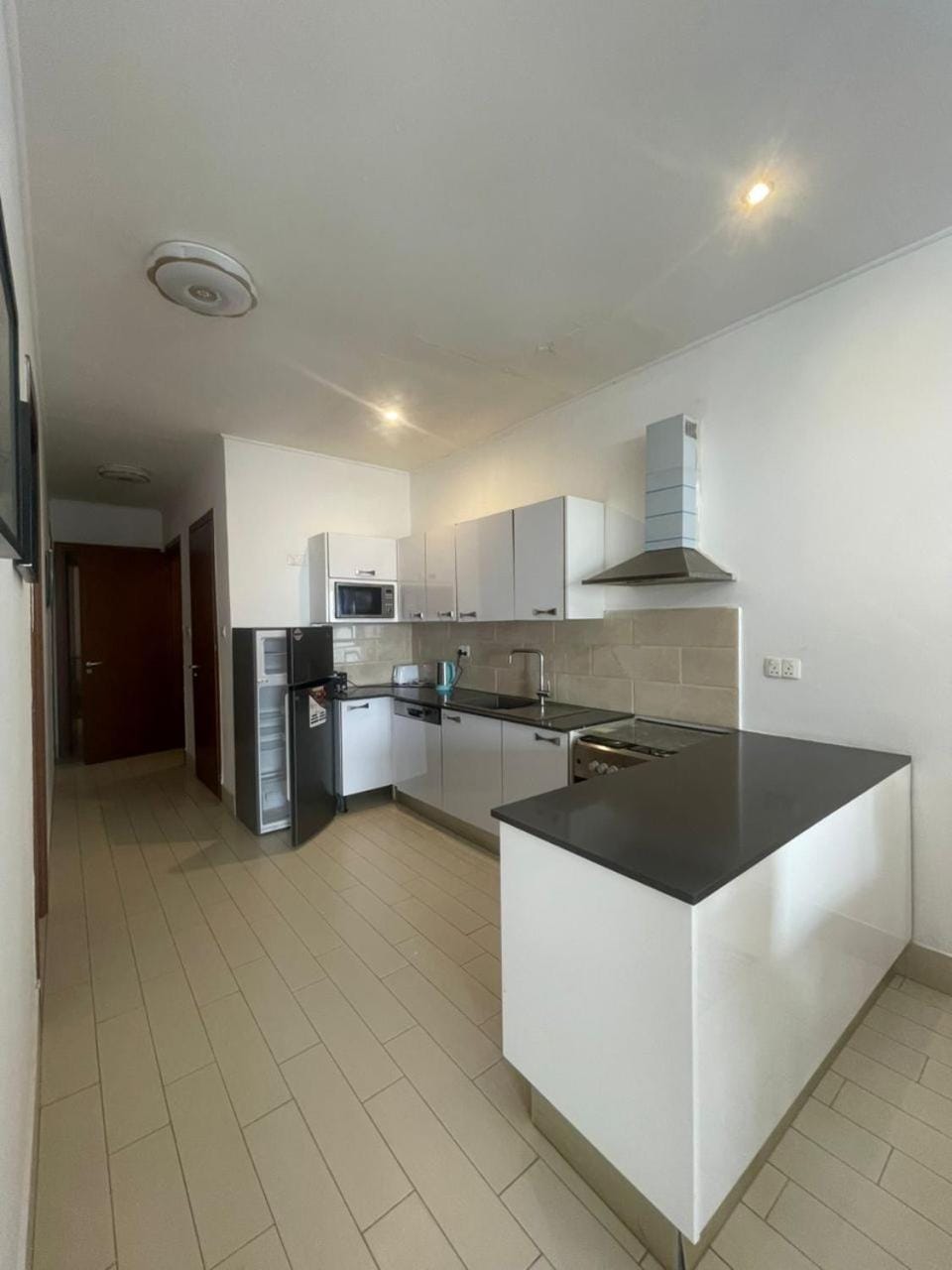 Kitchen or kitchenette, dishwasher, oven, stove
