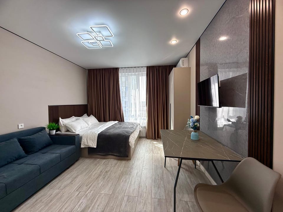 Bed, TV and multimedia, Living room, Seating area, Bedroom