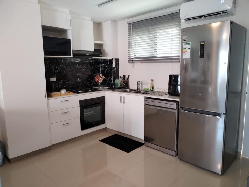 Kitchen or kitchenette, dishwasher, oven, stove