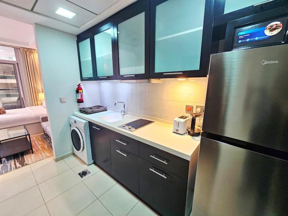 Kitchen or kitchenette, oven, stove, toaster, washing machine