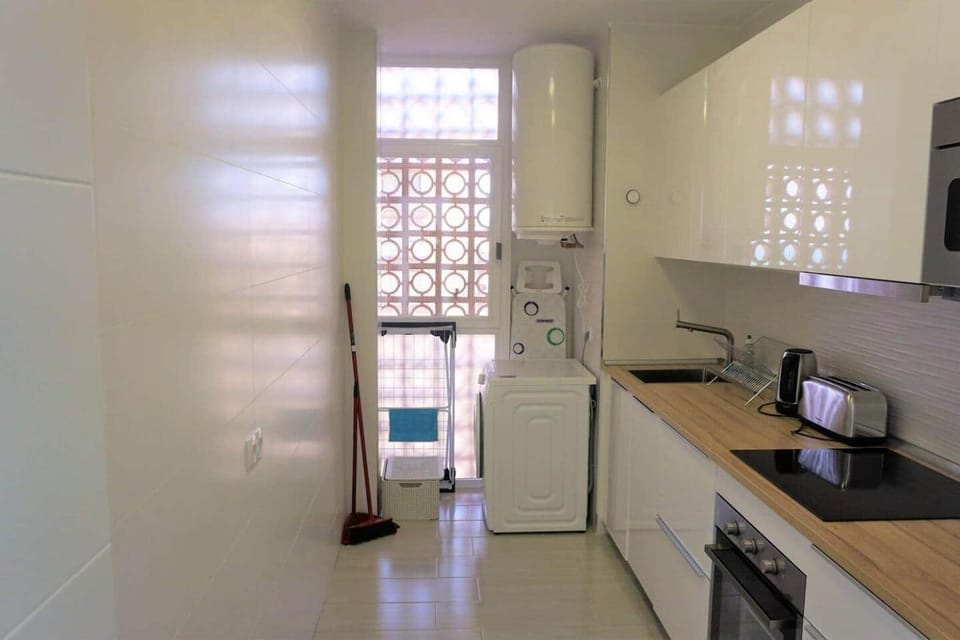 Kitchen or kitchenette, dishwasher, oven, stove, toaster, washing machine