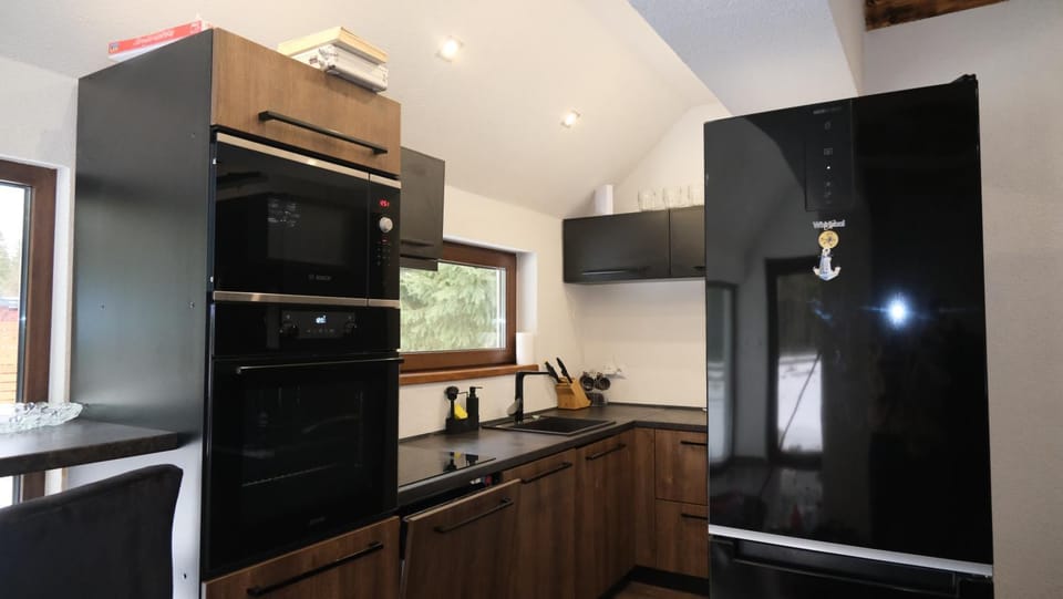 Kitchen or kitchenette, dishwasher, oven, stove