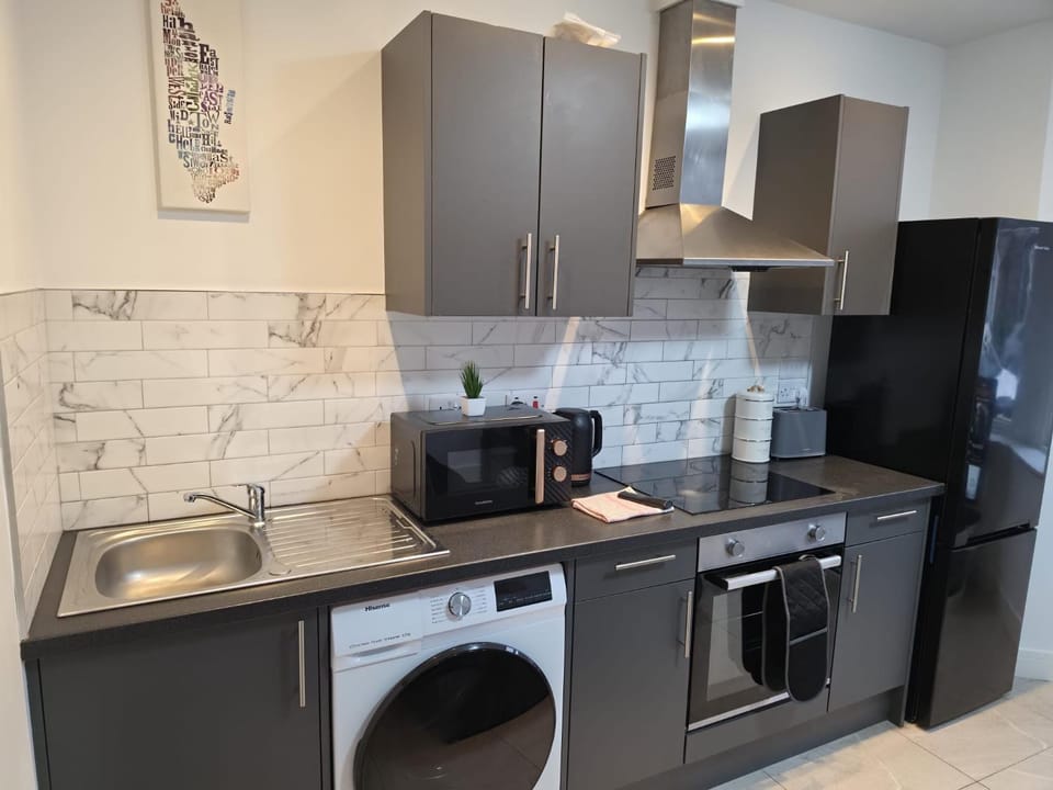 Kitchen or kitchenette, oven, stove, toaster, washing machine, dryer