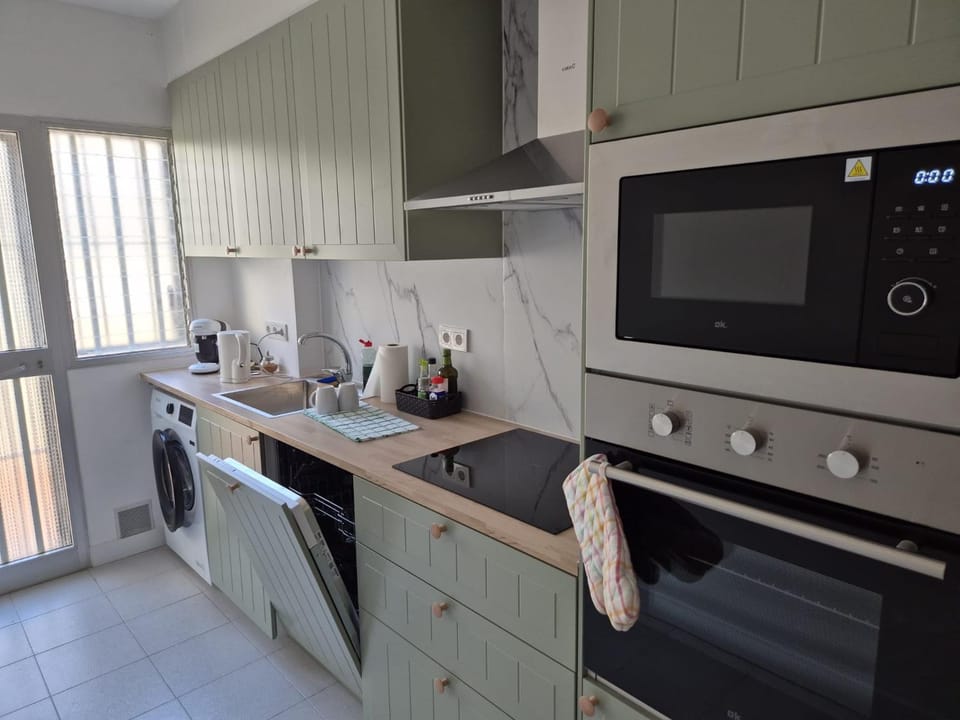 Kitchen or kitchenette, dishwasher, oven, stove, washing machine