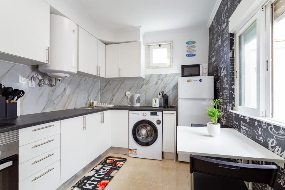 Kitchen or kitchenette, oven, stove, toaster, washing machine