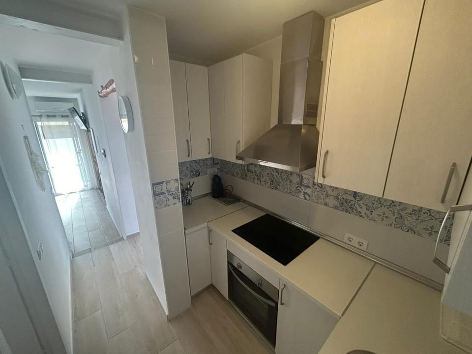 Kitchen or kitchenette, dishwasher, oven, stove