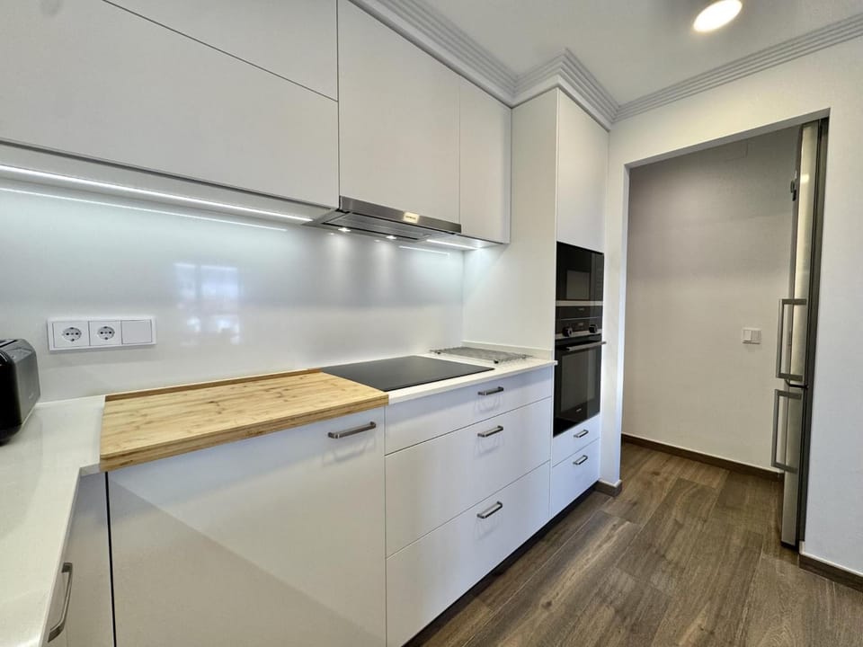 Kitchen or kitchenette, dishwasher, oven, stove