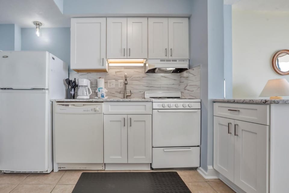 Kitchen or kitchenette, dishwasher, oven, stove