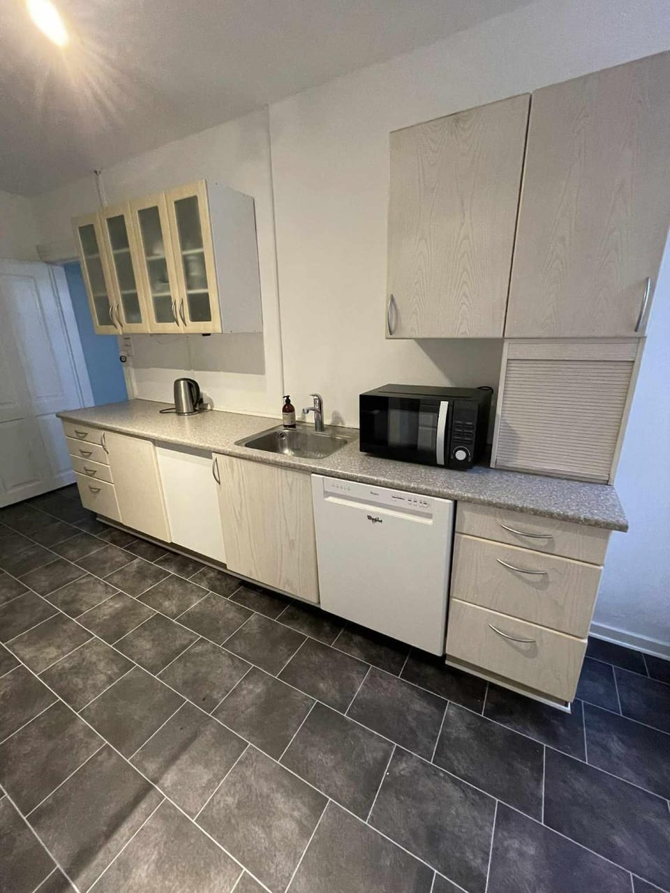 Kitchen or kitchenette, dishwasher, oven, stove